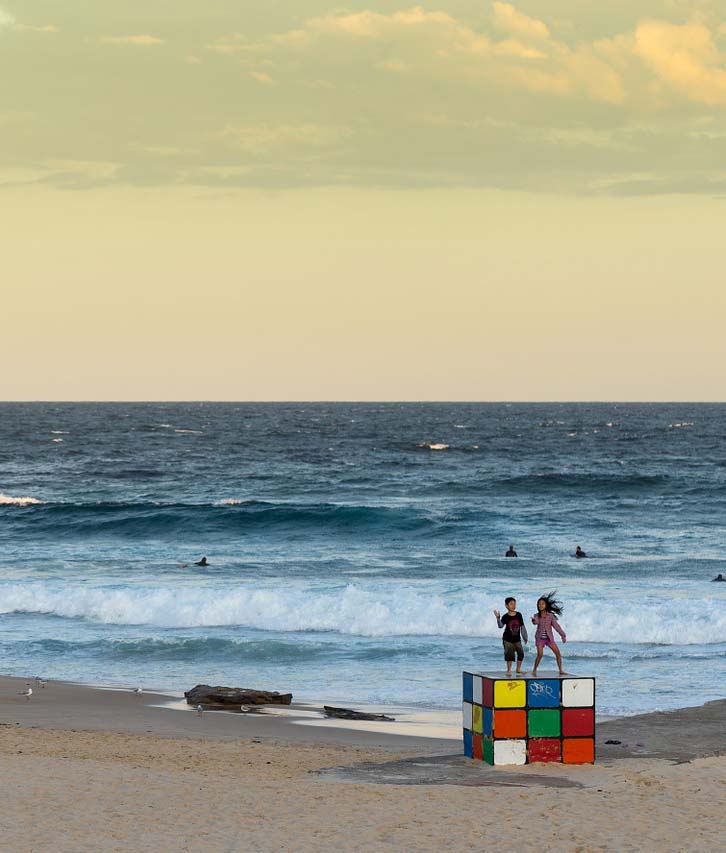 kids playing at the beach surrounded by buildings for strata cleaning maroubra 